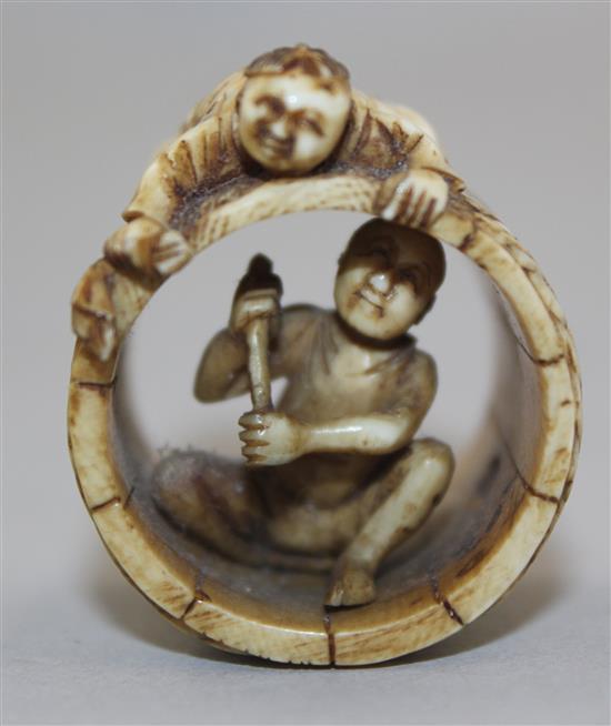 A Japanese ivory netsuke of two men constructing a barrel, Meiji period, 2.8cm